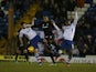 Clive Platt of Northampton Town contests the ball with Tommy Miller and Nathan Cameron of Bury during the Sky Bet League Two match on December 14, 2013