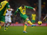 Gary Hooper of Norwich scores their fisrt goal during the Barclays Premier League match between Norwich City and Swansea City at Carrow Road on December 15, 2013