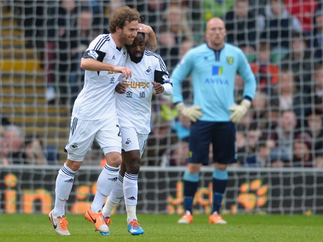 Nathan Dyer of Swansea is congratulated by his team mate Jose Canas after he scores their first goal during the Barclays Premier League match between Norwich City and Swansea City at Carrow Road on December 15, 2013