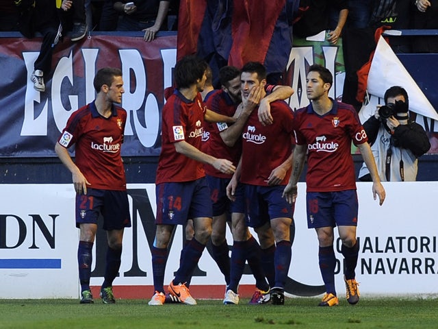Osasuna's players celebrate a goal during the Spanish league football match Osasuna vs Real Madrid at the Reyno de Navarra in Pamplona on December 14, 2013