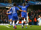 Oscar and Demba Ba of Chelsea celebrate after Danijel Georgijevski of Steaua scores an own goal to open the scoring during the UEFA Champions League Group E match on December 11, 2013