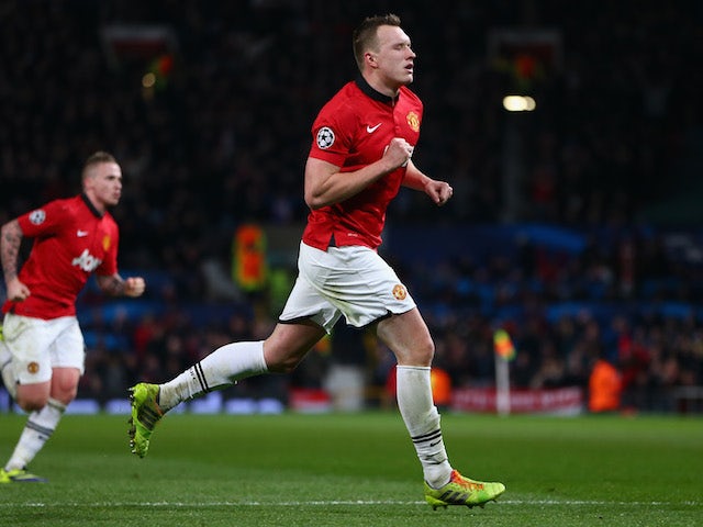 Phil Jones of Manchester United celebrates scoring the opening goal during the UEFA Champions League Group A match between Manchester United and Shakhtar Donetsk on December 10, 2013