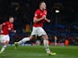 Phil Jones of Manchester United celebrates scoring the opening goal during the UEFA Champions League Group A match between Manchester United and Shakhtar Donetsk on December 10, 2013