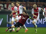 AC Milan's midfielder Riccardo Montolivo fights for the ball with Ajax's midfielder Davy Klaassen during the group H Champions League football match AC Milan vs Ajax, on December 11, 2013