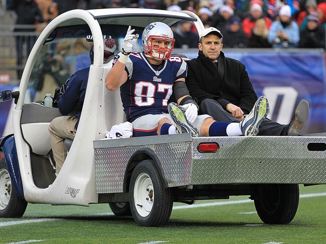 Rob Gronkowski #87 of the New England Patriots reacts to the cheers of fan as he leaves the field with an injury in the 3rd quarter against the Cleveland Browns at Gillette Stadium on December 8, 2013