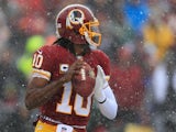 Quarterback Robert Griffin III of the Washington Redskins drops back to pass against the Kansas City Chiefs during the first quarter at FedExField on December 8, 2013