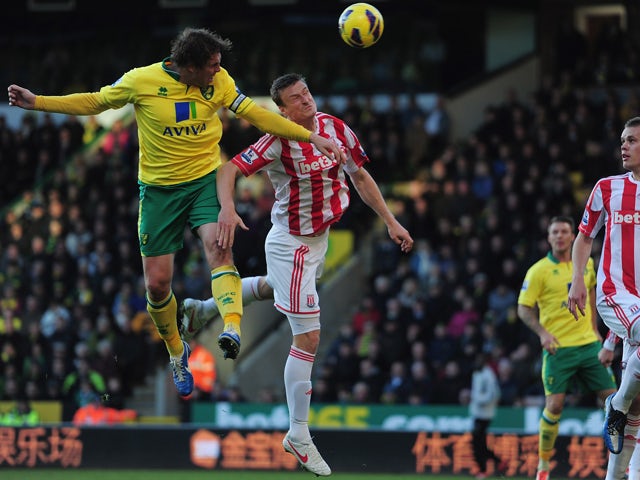 Robert Huth of Stoke City battles with Grant Holt of Norwich City during the Barclays Premier League match between Norwich City and Stoke at Carrow Road on November 3, 2012