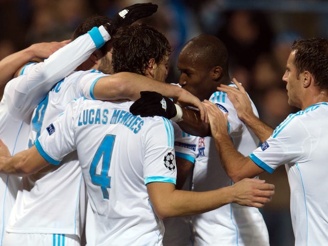 Marseille's Senegalese defender Souleymane Diawara celebrates with team mates after scoring a goal during an UEFA Champions League group F football match against Dortmund on December 11, 2013