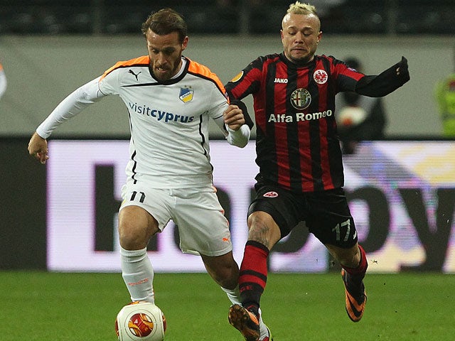 Frankfurt's Stephan Schroeck and Apoel's Nektarios Alexandrou in action during their Europa League group match on December 12, 2013