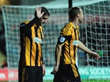 Hull striker and former Swansea player Danny Graham apologises to the Swansea fans after opening the scoring during the Barclays Premier league match between Swansea City and Hull City at the Liberty Stadium on December 9, 2013