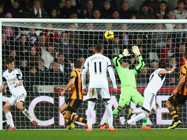 Chico Flores of Swansea City scores his sides equalising goal during the Barclays Premier League match between Swansea City and Hull City at the Liberty Stadium on December 9, 2013