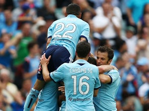 Ranko Despotovic of Sydney FC is swamped by team mates after scoring the second goal during the round 10 A-League match between Sydney FC and the Melbourne Heart at Allianz Stadium on December 15, 2013
