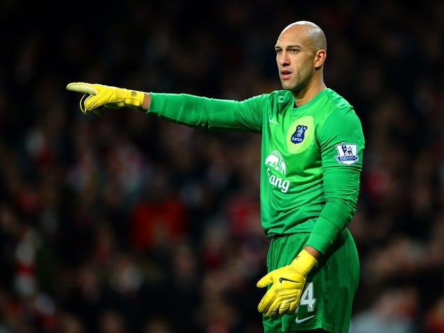 Tim Howard of Everton points during the Barclays Premier League match between Arsenal and Everton at Emirates Stadium on December 8, 2013