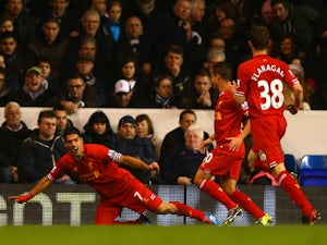 Captain Luis Suarez of Liverpool celebrates scoring the opening goal during the Barclays Premier League match between Tottenham Hotspur and Liverpool at White Hart Lane on December 15, 2013