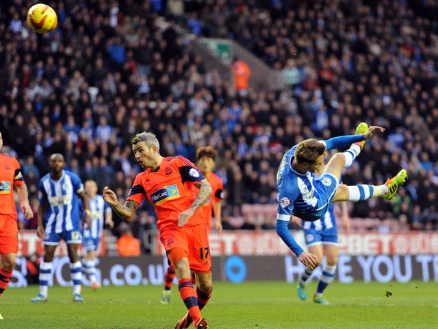 Nick Powell of Wigan Athletic scores the second goal of the game for his side during the Sky Bet Championship match between Wigan Athletic and Bolton Wanderers at the DW Stadium on December 15, 2013