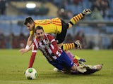 Atletico Madrid's forward Adrian Lopez (L) vies with Sant Andreu's goalkeeper Morales during the Spanish Copa del Rey (King's Cup) finals stage second-leg football match on December 18, 2013