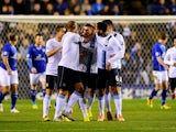 Man City's Aleksandar Kolarov is congratulated by teammates after scoring the opening goal against Leicester during their Capital One Cup quarter-final match on December 17, 2013