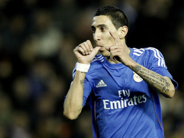 Real Madrid's Argentinian midfielder Angel di Maria celebrates his goal during the Spanish league football match Valencia vs Real Madrid at the Mestalla stadium in Valencia on December 22, 2013