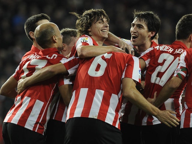 Athletic Bilbao's players celebrate a goal during the Spanish league football match Athletic Bilbao vs Rayo Vallecano at the San Mames stadium in Bilbao on December 22, 2013