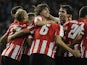Athletic Bilbao's players celebrate a goal during the Spanish league football match Athletic Bilbao vs Rayo Vallecano at the San Mames stadium in Bilbao on December 22, 2013