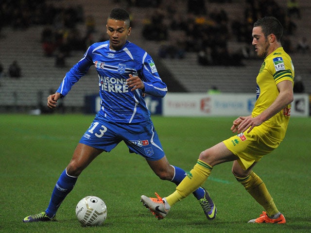 Auxerre's Axel Ngando and Nantes' Jordan Veretout in action during their French League Cup match on December 17, 2013