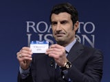 UEFA Champions League Final Ambassador, former Portuguese international footballer Luis Figo holds up the name of Barcelona during the draw for the last 16 of the UEFA Champions league tournament at the UEFA headquarters in Nyon on December 16, 2013