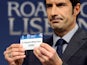 UEFA Champions League Final Ambassador, former Portuguese international footballer Luis Figo holds up the name of German club Bayern Munich during the draw for the last 16 of the UEFA Champions league tournament at the UEFA headquarters in Nyon on Decembe