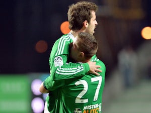 Saint Etienne's French midfielder Benjamin Corgnet (L) celebrates with a teammate after scoring a goal during the French L1 football match Saint-Etienne (ASSE) vs Nantes (FCNA) on December 21, 2013