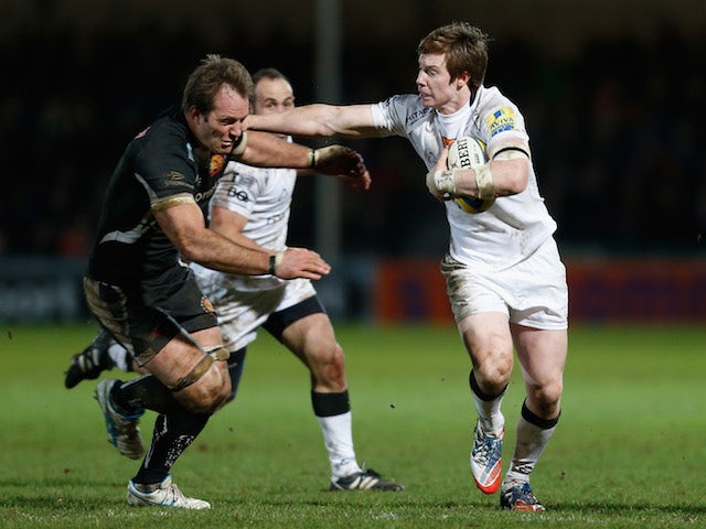 Danny Barnes of Newcastle attempts to hand off Kai Horstmann of Exeter during the Aviva Premiership match between Exeter Chiefs and Newcastle Falcons at Sandy Park on December 21, 2013
