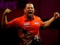 Devon Petersen of South Africa celebrates defeating Steve Beaton of England during his first round match on day four of the 2014 Ladbrokes.com World Darts Championships at Alexandra Palace on December 16, 2013
