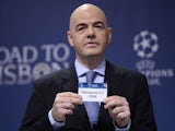 UEFA general secretary Gianni Infantino holds up the name of Turkish club Galatasaray during the draw for the last 16 of the UEFA Champions league tournament at the UEFA headquarters in Nyon on December 16, 2013