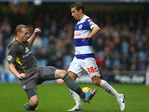 Gary O'Neil of Queens Park Rangers battles for the ball with Ritchie De Laet of Leicester City during the Sky Bet Championship match on December 21, 2013