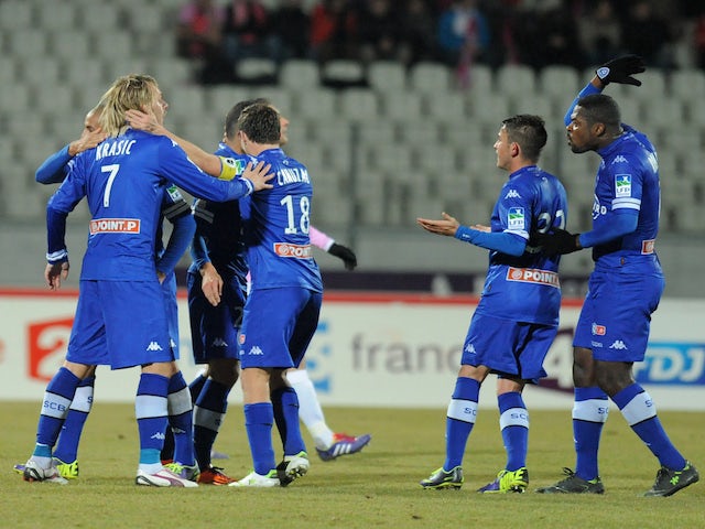 Bastia's Brazilian forward Ilan Araujo is congratulated by team mates after scoring a goal during a French League Cup round of sixteen football match against Evian on December 18, 2013