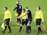 James McClean of Wigan Athletic talks to referee Keith Stroud, after the match is called off due to a waterlogged pitch during the Sky Bet Championship match against Sheffield Wednesday on December 18, 2013