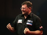 James Wade of England celebrates winning his first round match against Darren Webster of England during the Ladbrokes.com World Darts Championship on Day Six at Alexandra Palace on December 19, 2013