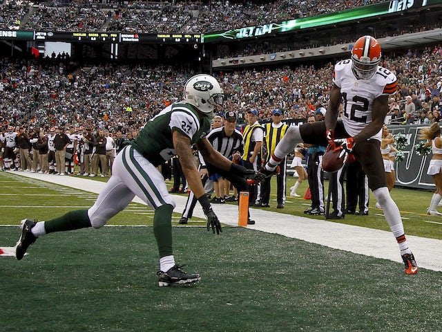 Josh Gordon of the Cleveland Browns tries to catch a pass in front of Dee Milliner of the New York Jets during their game at MetLife Stadium on December 22, 2013