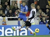 Real Madrid's French forward Karim Benzema vies for the ball with Valencia's French defender Jeremy Mathieu during the Spanish league football match on December 22, 2013