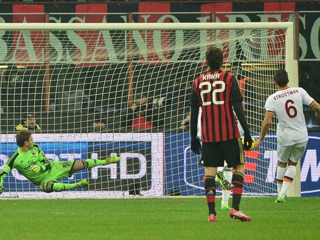 Roma's Kevin Strootman scores his team's second goal via the penalty spot against AC Milan during their Serie A match on December 16, 2013
