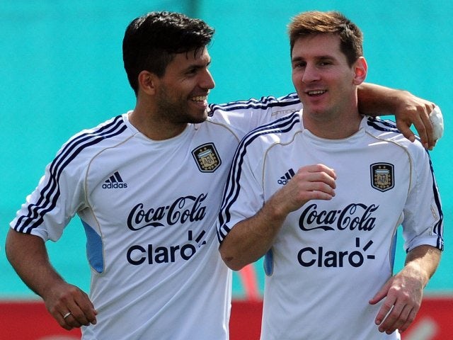 Lionel Messi and Sergio Aguero embrace during an Argentina training session on September 06, 2013.