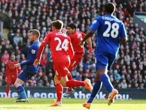 Luis Suarez of Liverpool shoots and scores during the Barclays Premier League match between Liverpool and Cardiff City at Anfield on December 21, 2013
