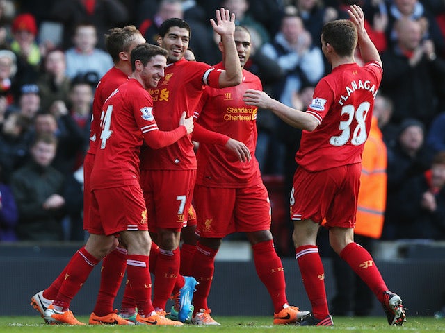 Luis Suarez of Liverpool celebrates with team mates after scoring during the Barclays Premier League match against Cardiff City on December 21, 2013