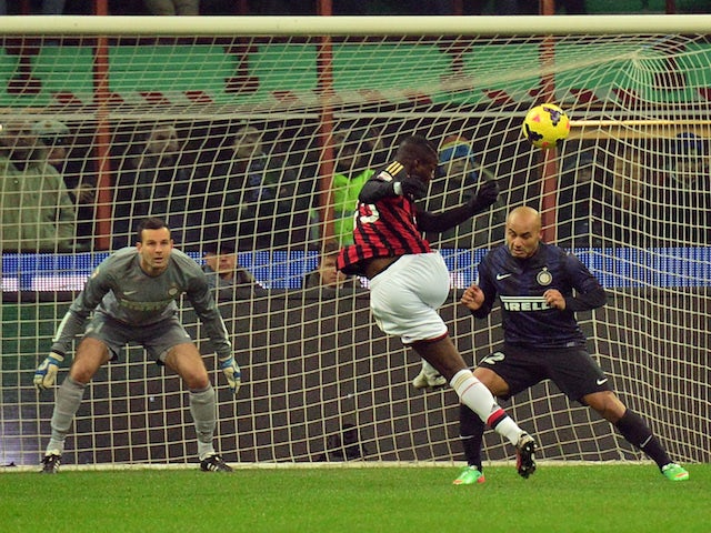 AC Milan's forward Mario Balotelli kicks the ball during the Italian Serie A football match Inter Milan vs AC Milan at San Siro Stadium in Milan on December 22, 2013