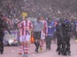Referee Mark Clattenburg brings the players off as heavy rain falls and play is halted during the Capital One Cup Quarter Final match between Stoke City and Manchester United on December 18, 2013