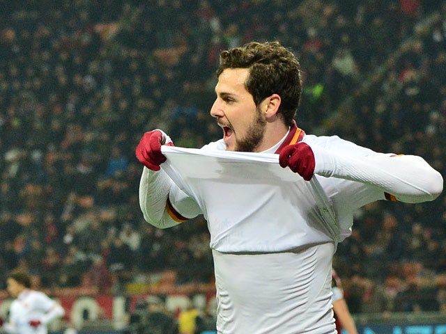 Roma's Mattia Destro celebrates after scoring the opening goal against AC Milan during their Serie A match on December 16, 2013