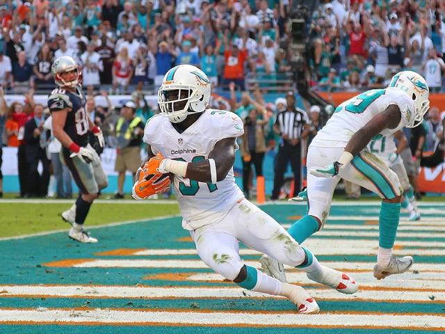 Michael Thomas #31 of the Miami Dolphins celebrates a game clinching interception during a game against the New England Patriots at Sun Life Stadium on December 15, 2013