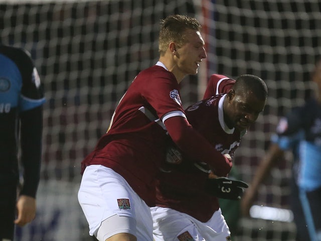 Izale McLeod of Northampton Town is congratulated by team mate Luke Norris after scoring his sides goal during the Sky Bet League Two match between Northampton Town and Wycombe Wanderers at Sixfields Stadium on December 21, 2013