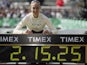 Paula Radcliffe poses next to her world record time after the London Marathon on April 13, 2003