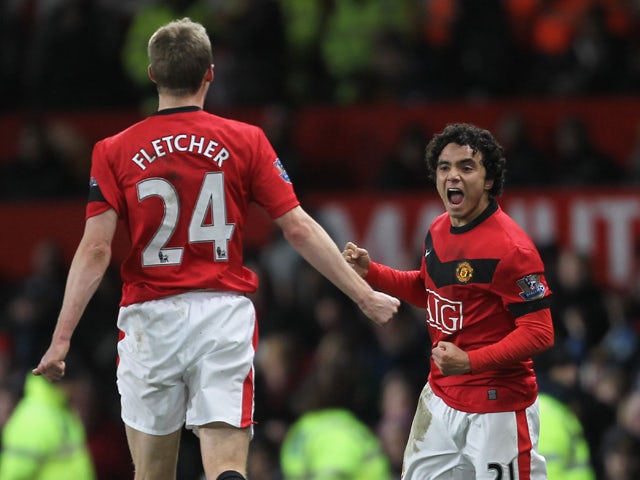  Rafael Da Silva of Manchester United celebrates scoring his team's third goal with team mate Darren Fletcher during the Barclays Premier League match between Manchester United and Wigan Athletic at Old Trafford on December 30, 2009