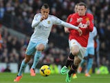 Ravel Morrison of West Ham United competes with Wayne Rooney of Manchester United during the Barclays Premier League match between Manchester United on December 21, 2013