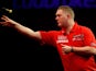 Ricky Evans in action against Ronnie Baxter during their first round match of the World Darts Championship on December 16, 2013